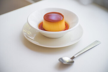 Caramel pudding in white plate