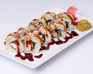 Sushi small set served on a white plate over white background. Traditional Asian Japanese cuisine concept.