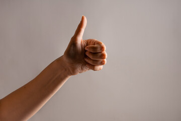 Hand gestures, Thumbs up, like approval. women's hand. Hand gestures