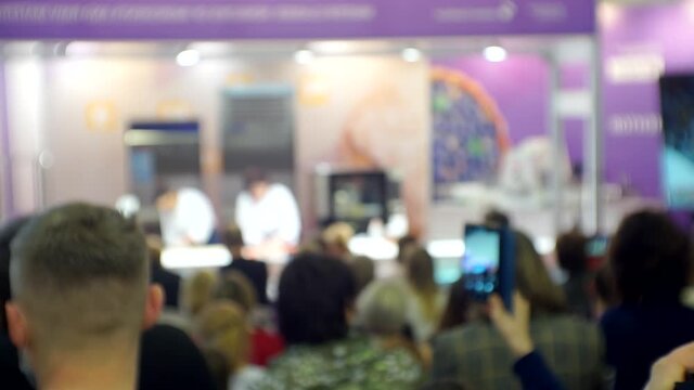 Chefs conduct a master class in front of the public. Blurred background