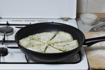 Onion cheese cakes. Homemade cheese, green onions and bacon flatbread. Flatbread with onion cheese and beacon fried in a pan.