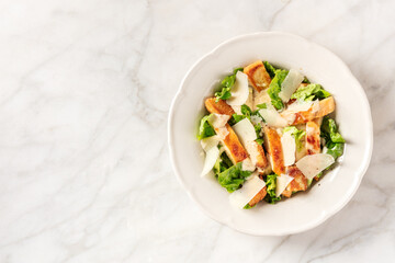 Caesar salad with grilled chicken meat, romaine leaves and Parmesan