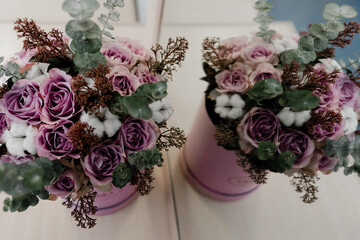 the bride's lovely wedding bouquet is in a cardboard stand. bouquet made by florists. a bouquet of flowers standing on a chair. festive flowers of the bride.