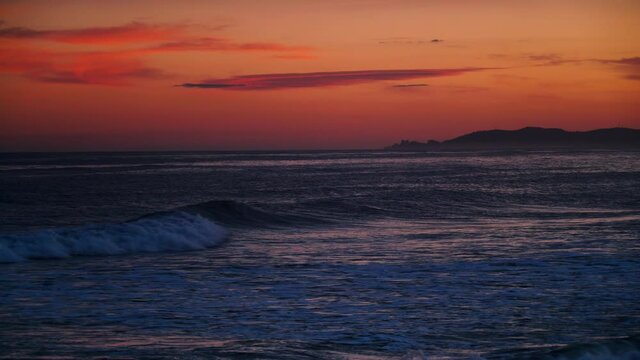 Red orange sky after sunset over sea. Nature, coastal landscape. Capi Corb, Mediterranean coast of Spain.
