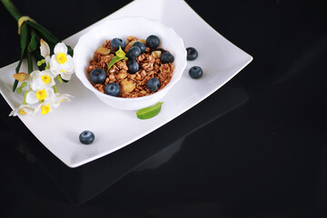 A healthy breakfast cereal with milk and fruit. Oat and corn flakes with chocolate and yogurt. The concept of healthy and vegetarian food.