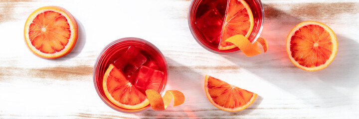 Orange cocktails panorama with blood oranges, top shot