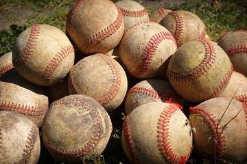 Old worn practice baseball on field