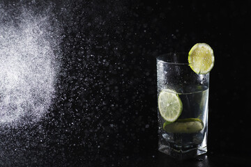 Lime water. Drinking water with fresh lime. Mineral water. Healthy, mineral-rich, refreshing water with lime.