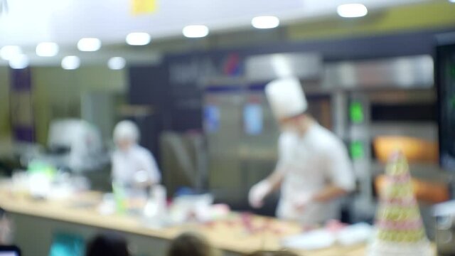 Chefs conduct a master class in front of the assembled audience.