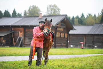 Traditional Slavic rituals in the rustic style. Outdoor in summer. Slavic village farm. Peasants in elegant robes.