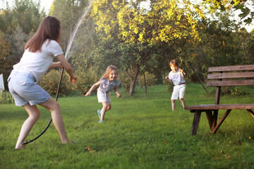 Fototapeta premium Children on a walk in the summer. Children indulge in the country. Laughter and splashing water.