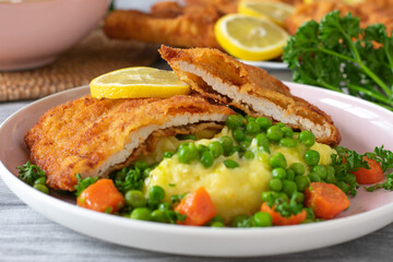 Schnitzel with mashed potatoes and vegetables on a plate