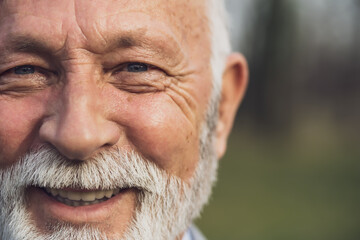 Close up portrait of happy senior man. Part of senior man face with copy space on image.