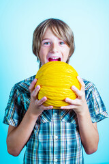 little boy with a big yellow melon Healthy food concept