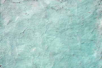 Old wall texture with cracked paint of green color