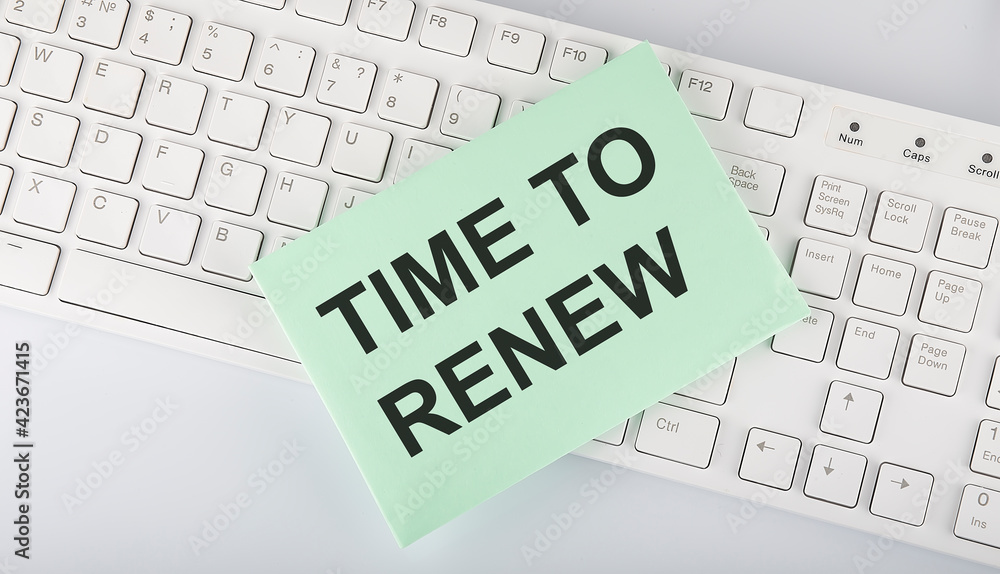 Poster text time to renew on envelope on keyboard on the white background