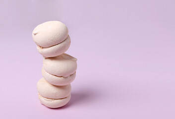Stack of delicious soft zephyr on the pink background.Empty space