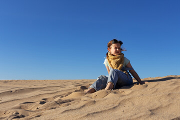 Fototapeta na wymiar Little kid girl in goggles in sand desert