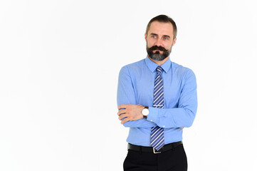 Portrait of confident middle-aged businessman in blue shirt with a beard and mustache standing on...