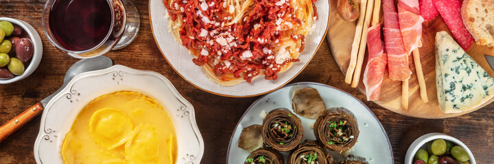 Italian food variety panorama, shot from above. Antipasti, ravioli, etc