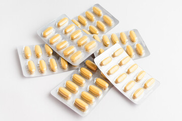 Close up of different medicine pills, tablets and vitamins isolated on white background, pharmaceutical picture taken with soft focus.