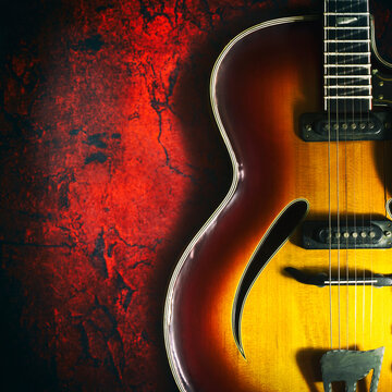 Old, jazz electric guitar on a red grunge background. Copy space. Close-up. Background for music festivals, concerts. Musical education. Concert concept.