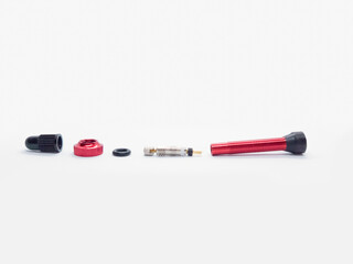 disassembled bicycle tubeless presta valve on white background