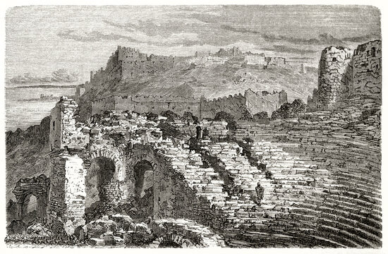part of roman theater ruins in Sagunto, Spain, and rock with fortress far in the distance. Etching style art by Dore, Le Tour du Monde, 1862