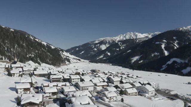 Flying Ariel over Obertilliach during peak snow season on a bright sunny day