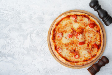 Top view of pizza Margherita on gray surface