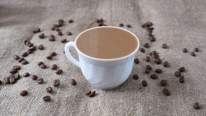 a cup of coffee with milk on a bag of coffee beans