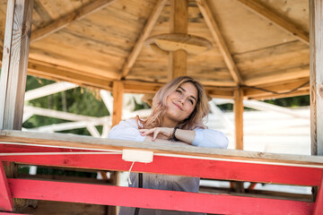 female model posing in wooden gazebo near lake ar sity park