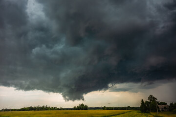 Fototapeta na wymiar Supercell storm clouds with wall cloud and intense rain