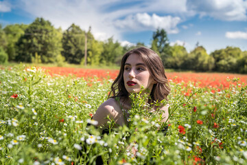 Obraz na płótnie Canvas Beautiful girl on the flowers field, sunny day