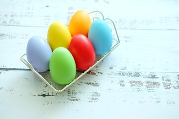 Close up of Colorful Easter Eggs on white wooden background.