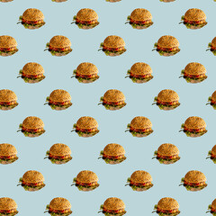 Burger seamless pattern on blue background. A tasty hamburger with beef, cheese, and lettuce. Fast...
