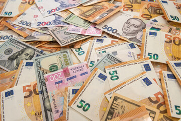 Fototapeta na wymiar Money background from different countries dollars euro and hryvnia banknotes