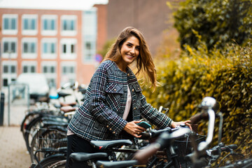 Fototapeta na wymiar Woman on street with bike.