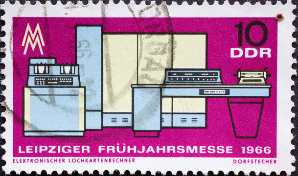 GERMANY, DDR - CIRCA 1966  : a postage stamp from Germany, GDR showing a historical electronic punch card calculator, trade fair symbol symbol. Leipzig Spring Fair