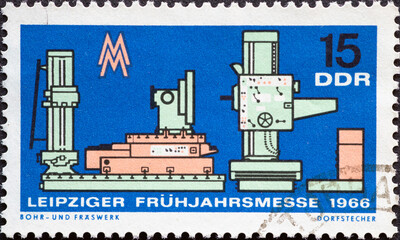 GERMANY, DDR - CIRCA 1966  : a postage stamp from Germany, GDR showing a historical boring and milling mill, trade fair symbol symbol. Leipzig Spring Fair