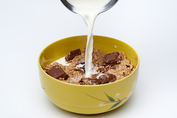 Pouring milk over cereals