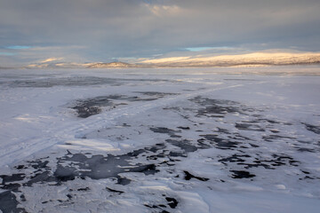 The frozen lake Torneträsk in Swedish Lapland. Beautiful ice forms create an amazing sight.