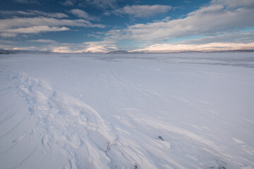 The frozen lake Torneträsk in Swedish Lapland. Beautiful ice forms create an amazing sight.