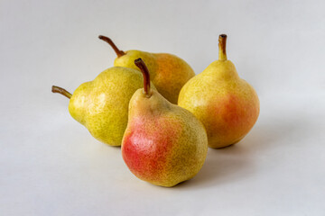 Four ripe yellow pears with red sides