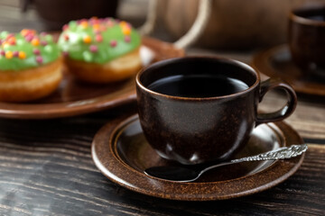 Brown cup of tea on a wooden table. Still life.