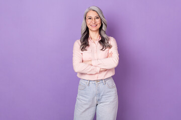 Portrait of attractive clever smart cheerful woman librarian folded arms isolated over violet purple color background