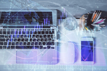 Multi exposure of forex graph drawing over desktop background with computer. Concept of financial analysis. Top view.
