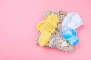 Baby concept. Baby cloth and goods on pastel pink background. Place for text. View from above. Flat Lay- Image