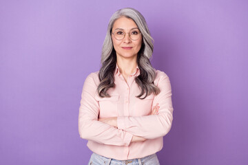 Portrait of attractive clever smart content woman folded arms isolated over violet purple color background