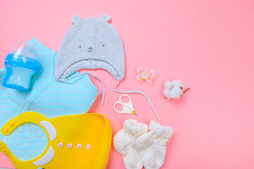 Baby concept. Baby cloth and goods on pastel pink background. Place for text. View from above. Flat...